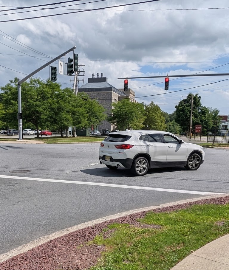 Top-down intersection diagram with the car positioned far right and the turning arc shown