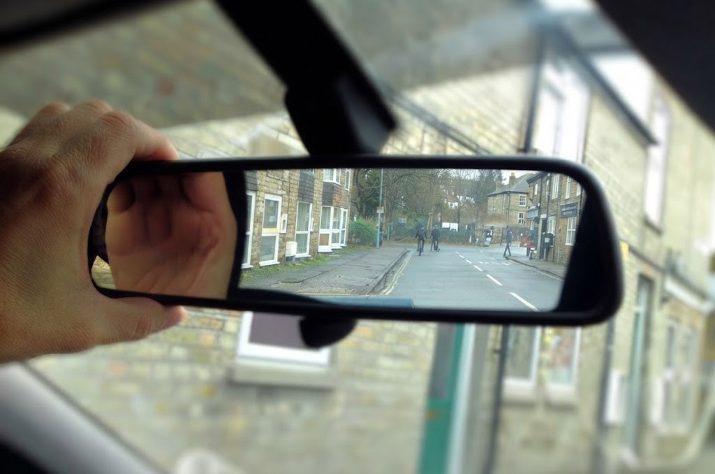 Question image: Before changing lanes, in addition to checking the mirrors, what must the driver