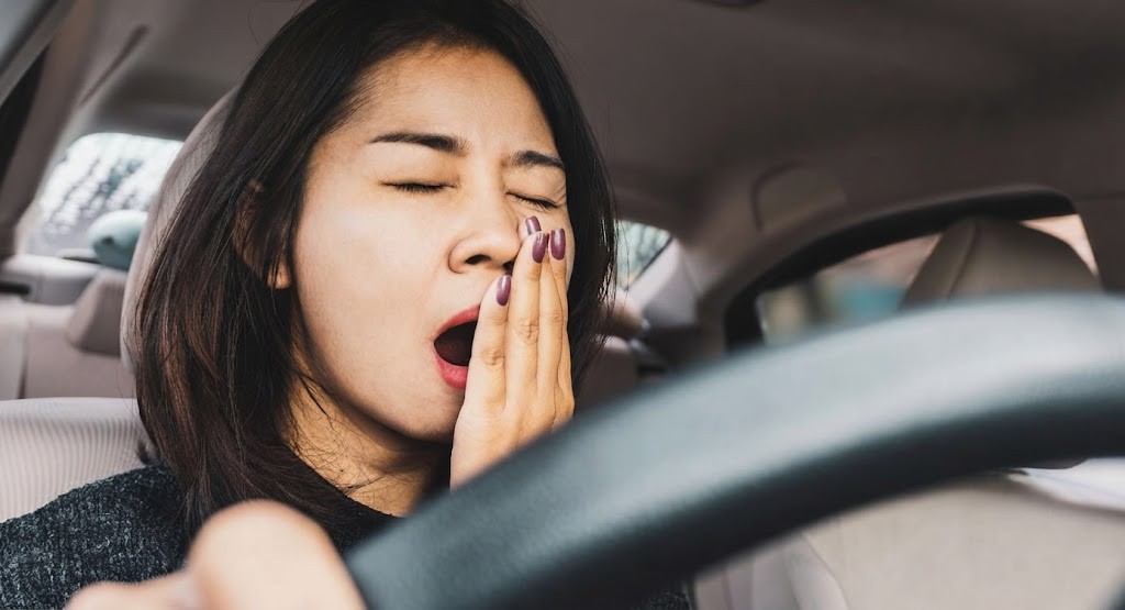 Question image: If you feel symptoms of fatigue while driving, the correct action is…