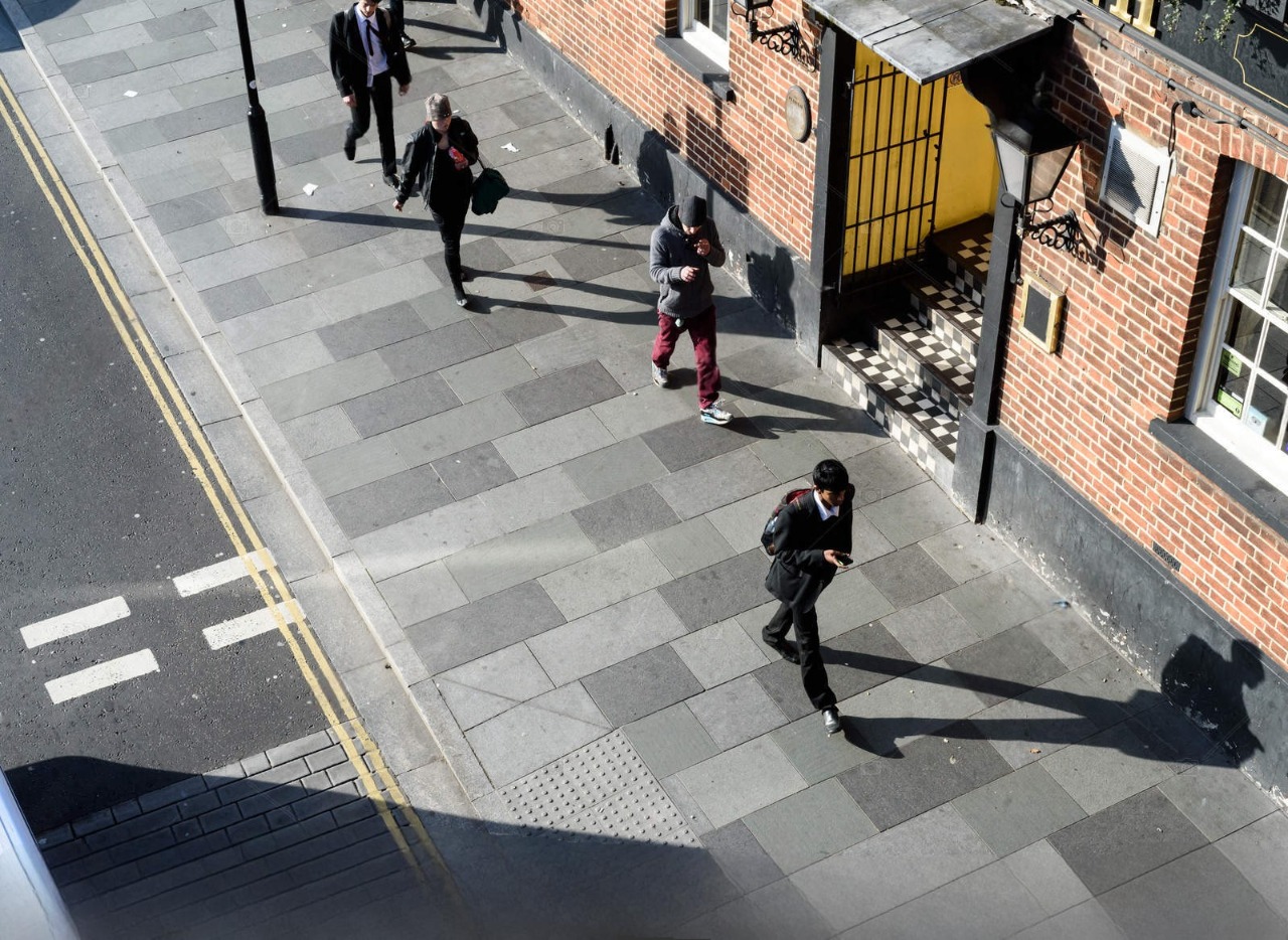 Question image: Where should pedestrians walk in towns and cities whenever possible?
