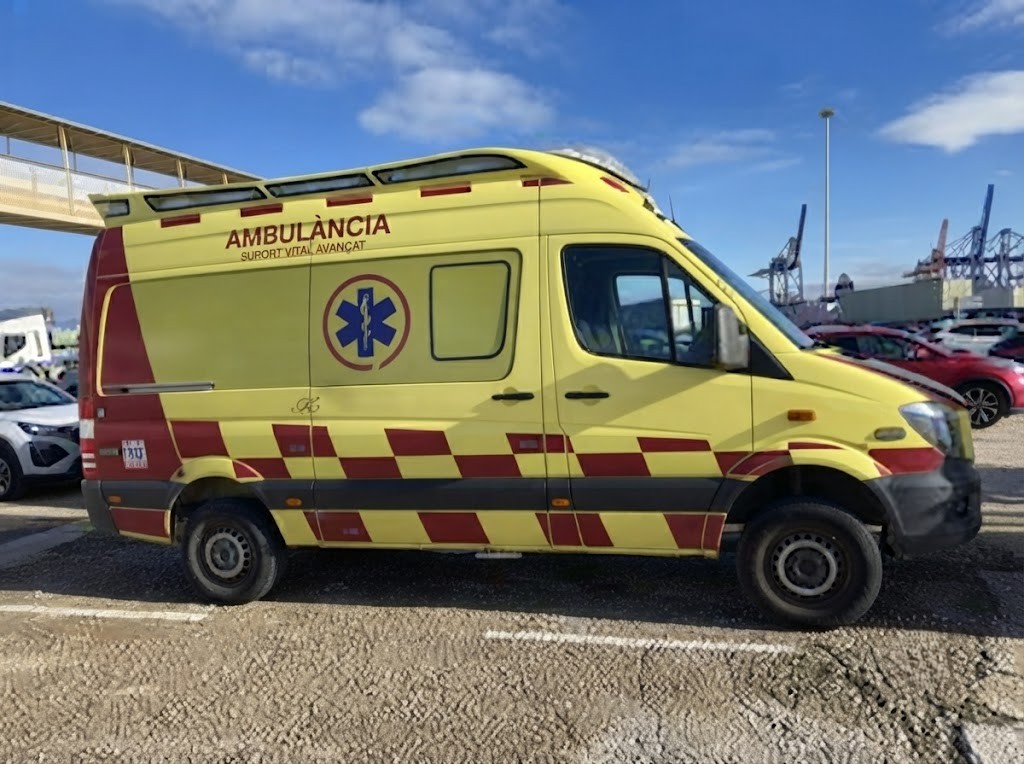 Question image: When an emergency vehicle is approaching, what must the driver never do?