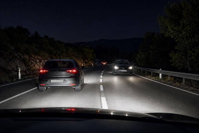 Question image: Driving at night on an unlit road with high beams, a vehicle approaches from the