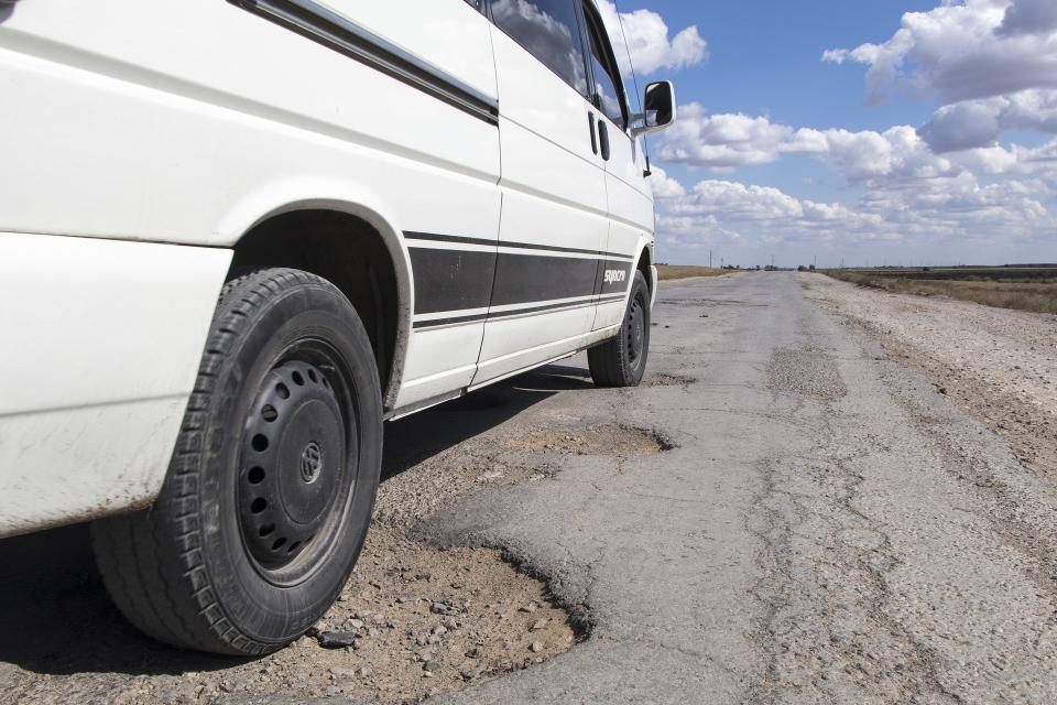 Question image: When driving over an area with loose gravel or unexpected potholes, what is the