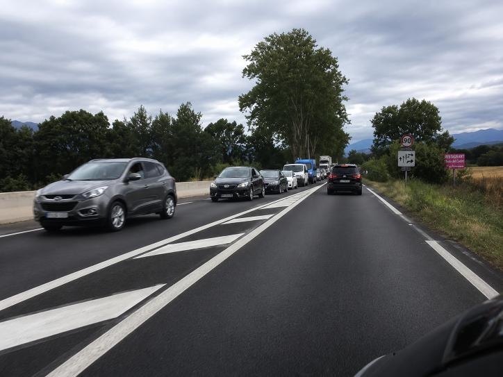 Question image: On a road with one lane in each direction, which vehicles must keep to the right