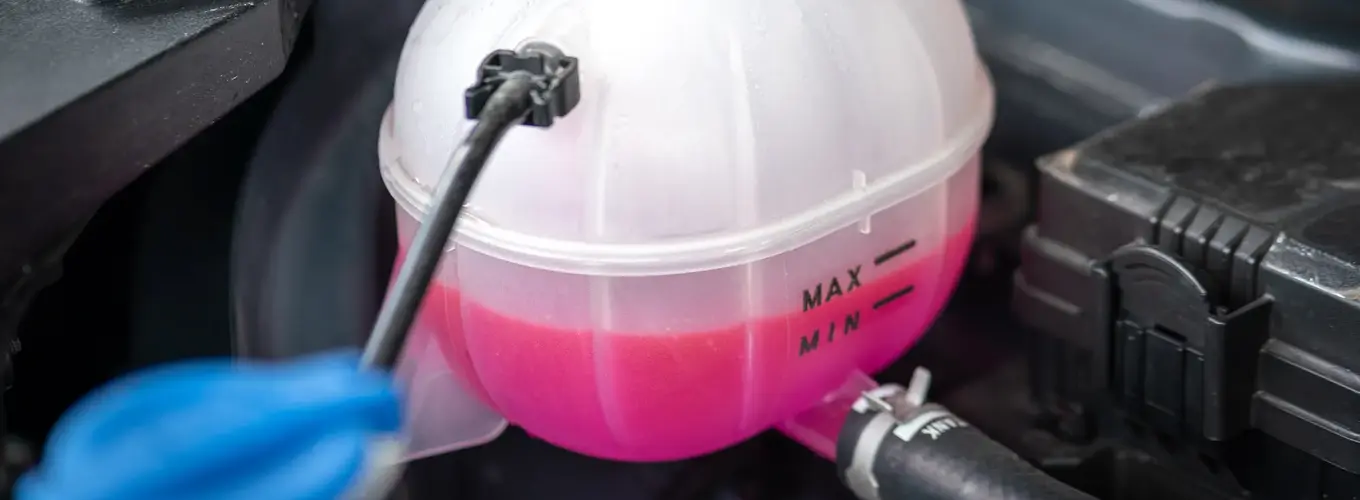 Question image: Where and how is the coolant level checked?