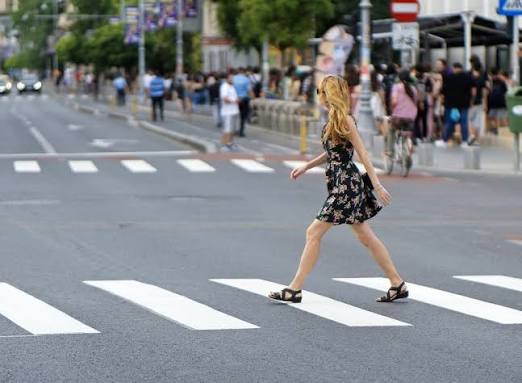 Question image: When crossing the road at a pedestrian crossing, a pedestrian must: