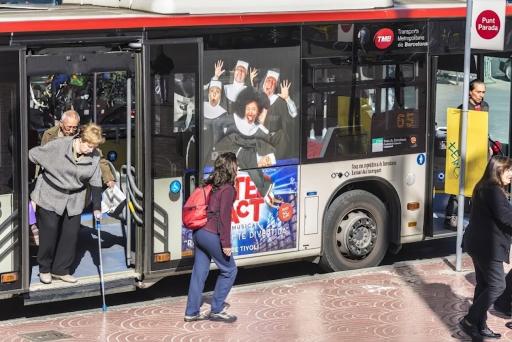 Question image: A bus is stopped and a passenger steps down between the vehicle and the pavement