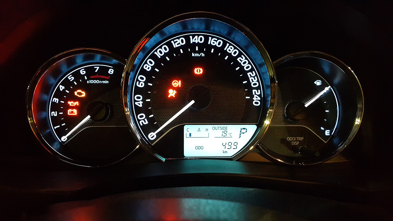 Question image: A warning light comes on the instrument cluster while you are driving. What shou